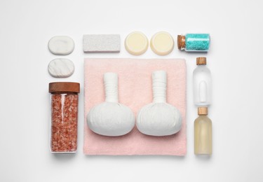 Photo of Flat lay composition with herbal massage bags and other spa products on white background