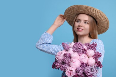 Beautiful woman with bouquet of spring flowers on light blue background, space for text