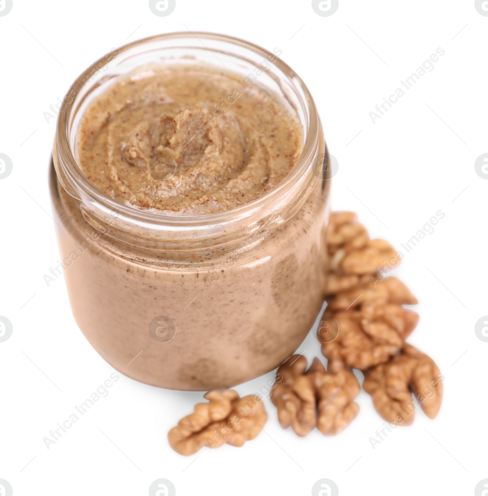 Photo of Tasty nut paste in jar and walnuts isolated on white