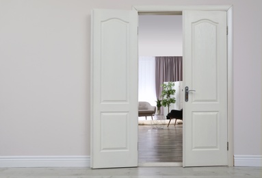 Stylish room interior, view through open door. Space for text