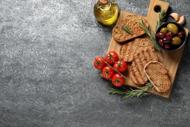 Photo of Flat lay composition with bruschettas on grey table, space for text