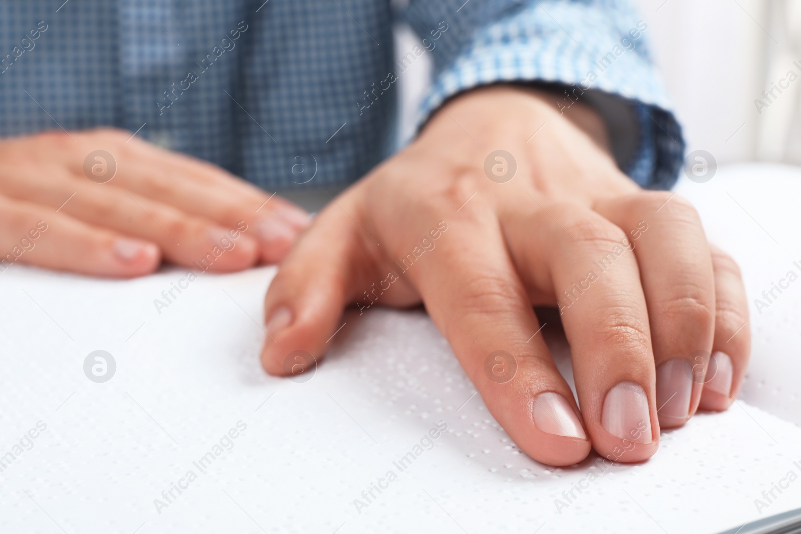 Photo of Blind person reading book written in Braille, closeup