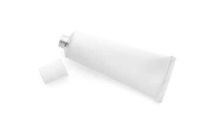 Photo of Open tube of ointment on white background, top view