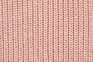 Texture of cozy warm sweater as background, closeup