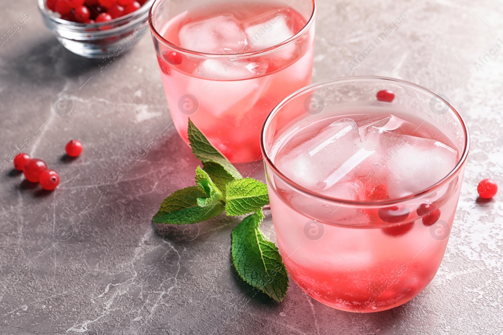 Photo of Refreshing natural lemonade in glasses on table