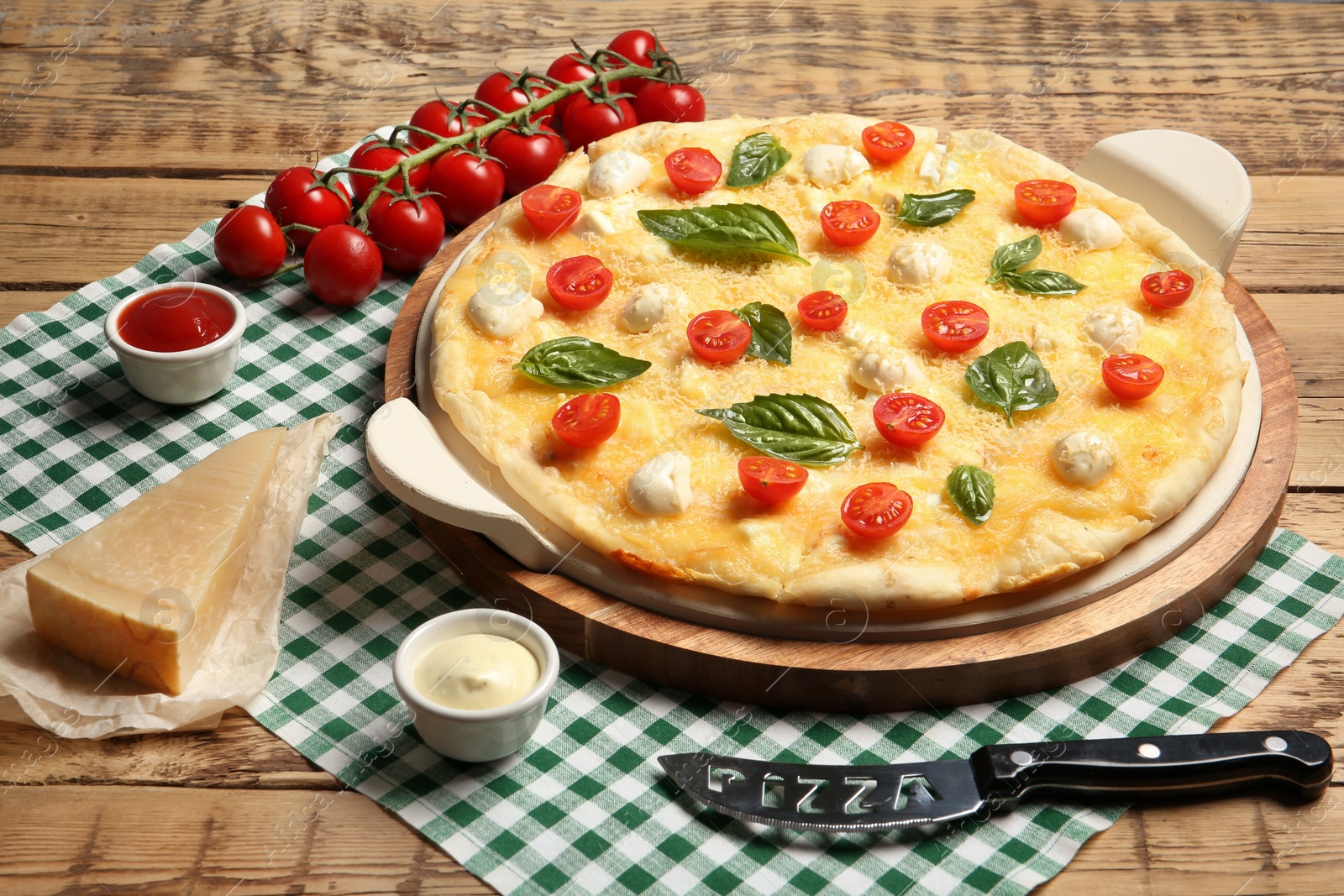 Photo of Composition with tasty homemade pizza on wooden table