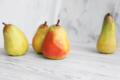 Photo of Juicy pears and double-sided backdrop on table in photo studio