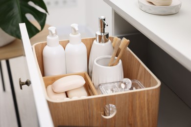 Different bath accessories and personal care products in drawer indoors