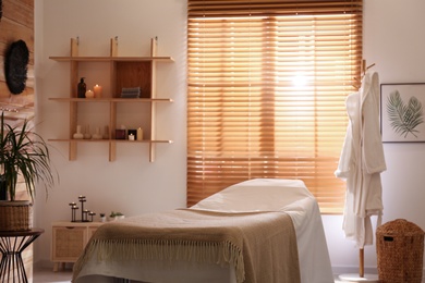 Stylish massage room interior in spa salon