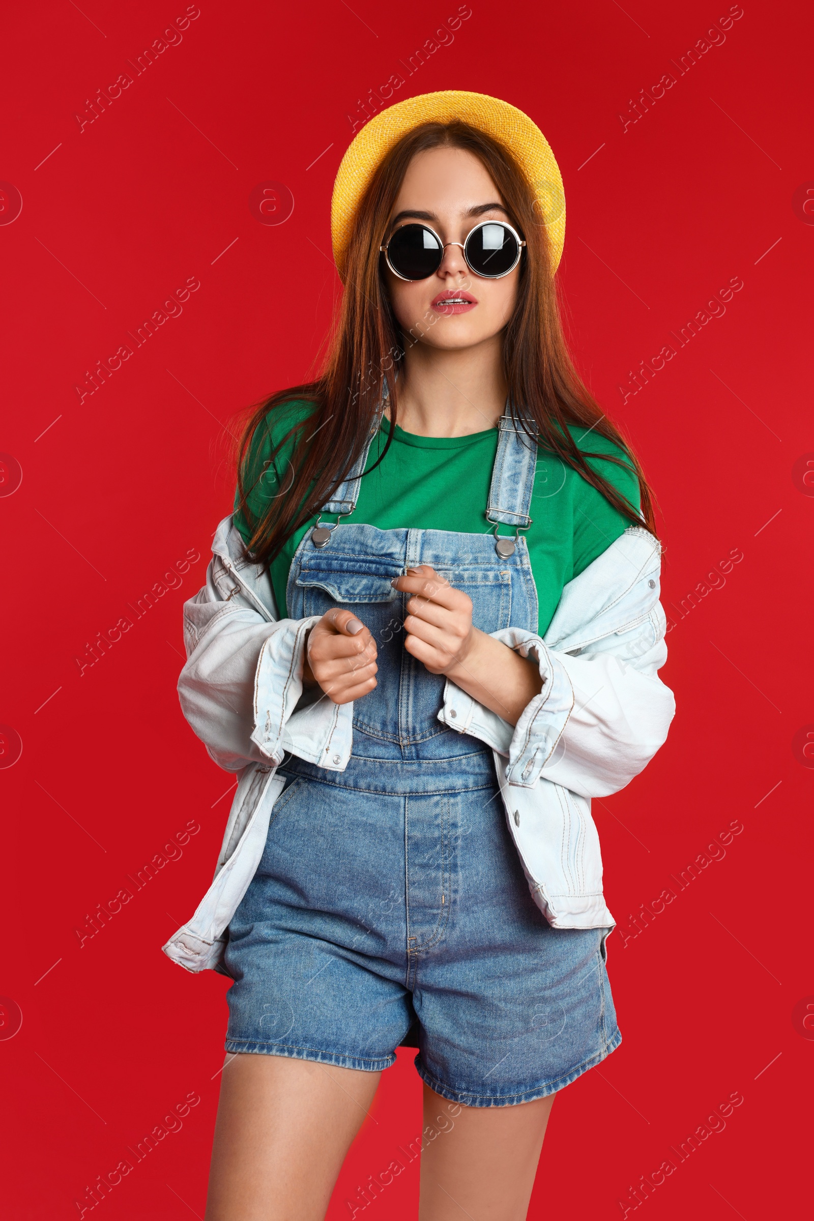 Photo of Portrait of beautiful woman on red background