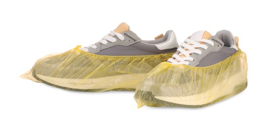 Men's sneakers in yellow shoe covers isolated on white