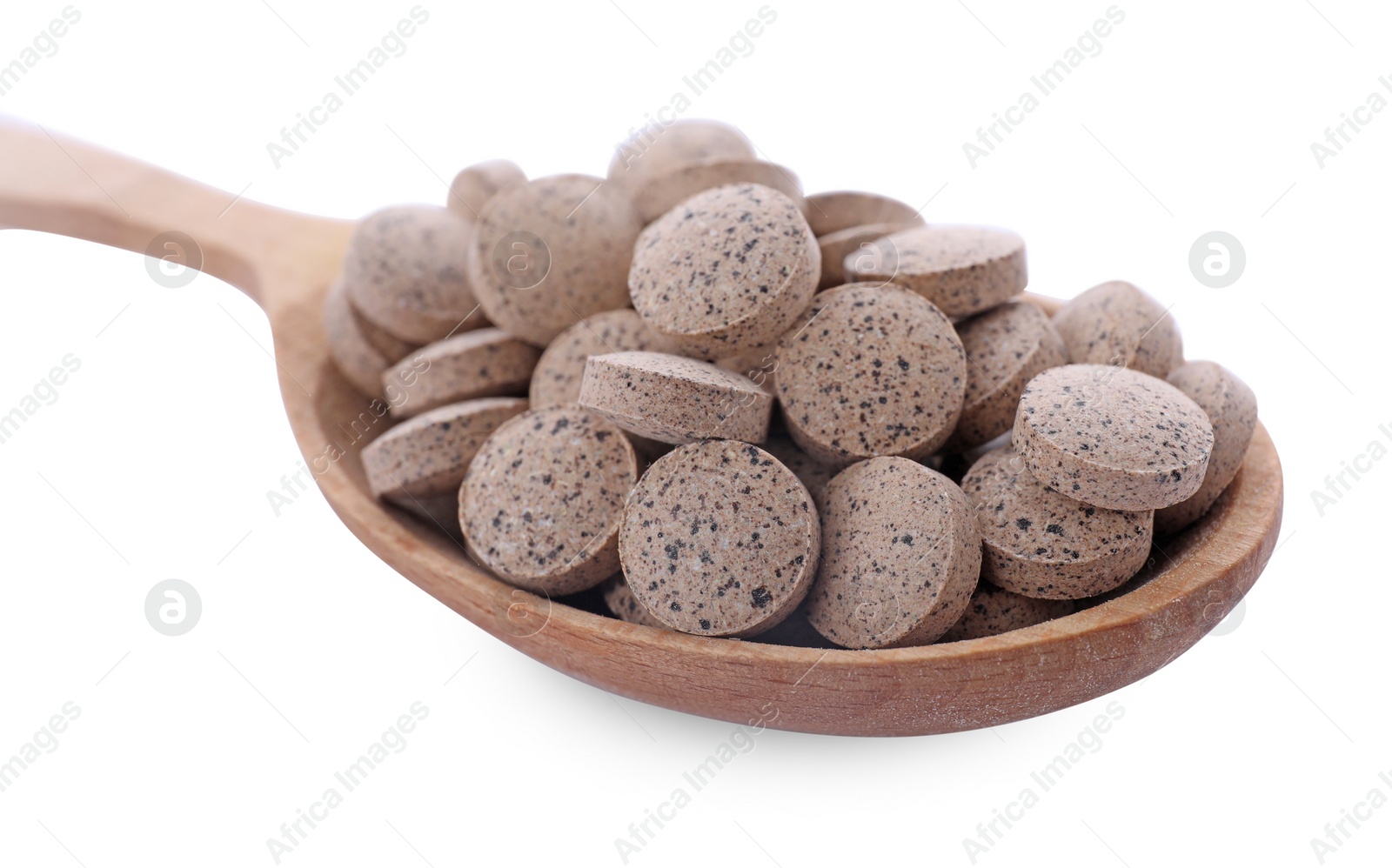 Photo of Brewer's yeast tablets in spoon on white background