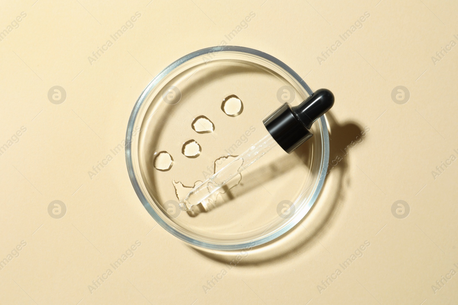 Photo of Petri dish and cosmetic product on beige background, top view