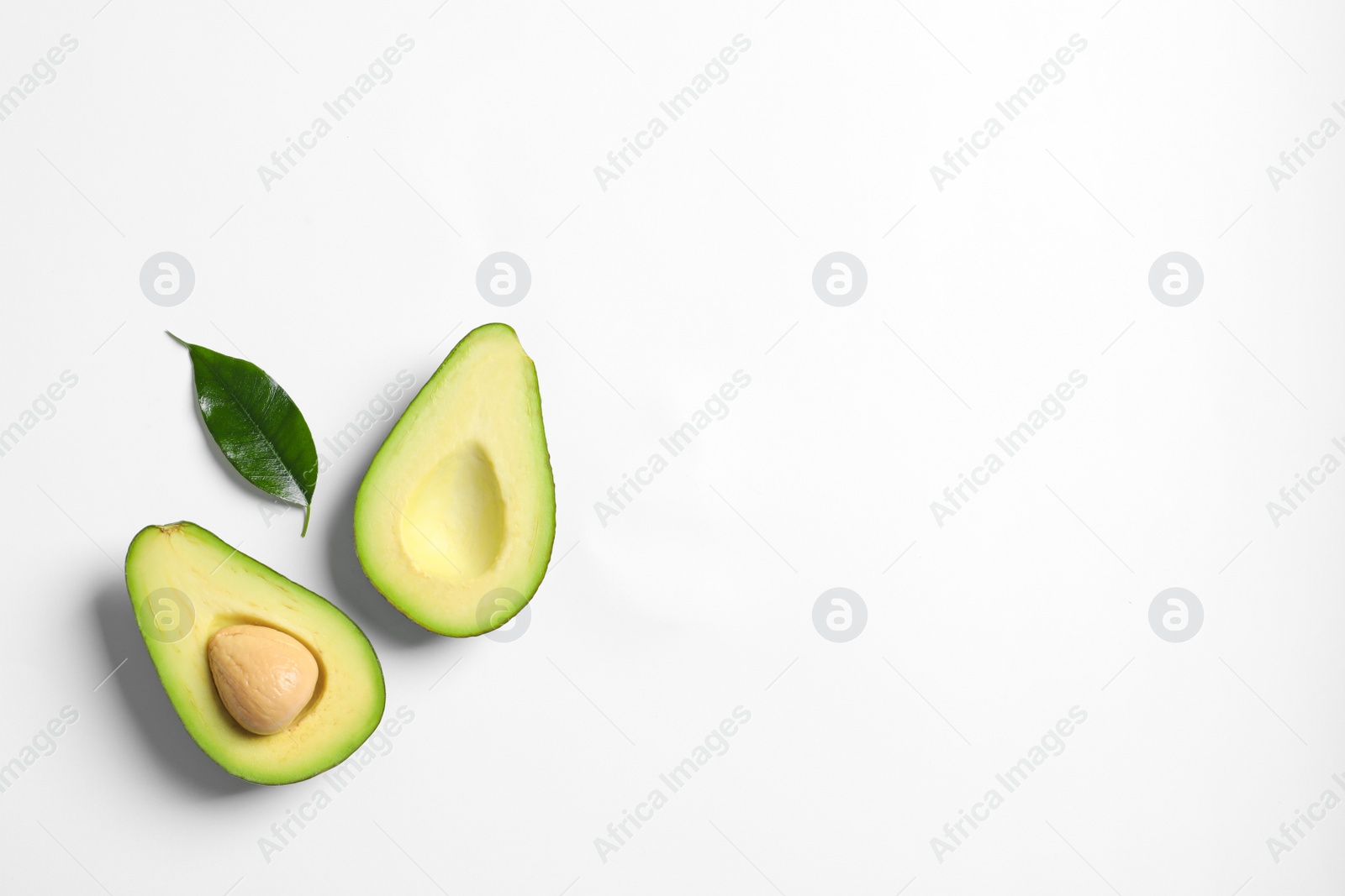 Photo of Ripe sliced avocado on white background