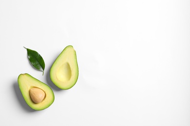 Photo of Ripe sliced avocado on white background