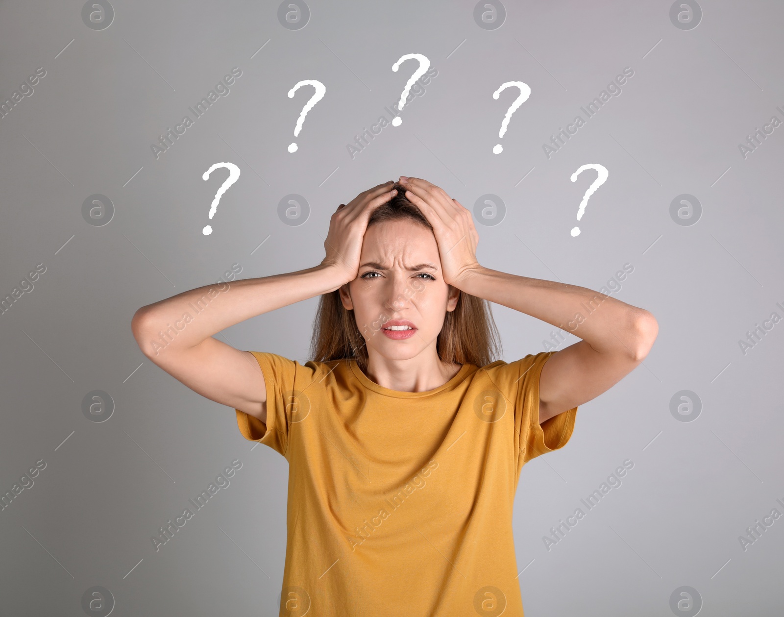 Image of Amnesia. Confused young woman and question marks on light grey background