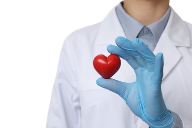 Photo of Doctor wearing light blue medical glove holding decorative heart on white background, closeup