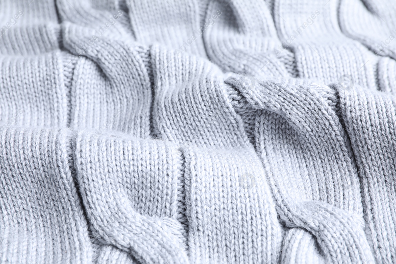 Photo of Warm knitted sweater as background, closeup view