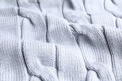 Photo of Warm knitted sweater as background, closeup view