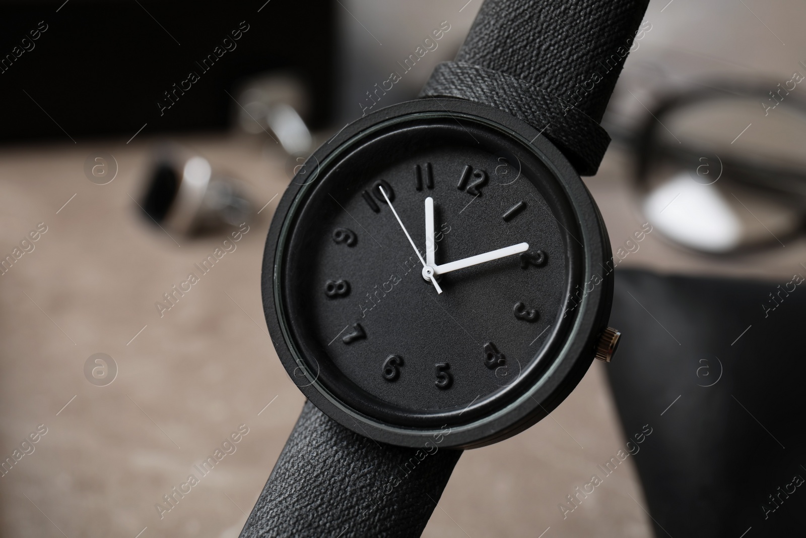 Photo of Stylish wrist watch on blurred background. Time management