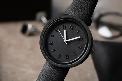 Photo of Stylish wrist watch on blurred background. Time management