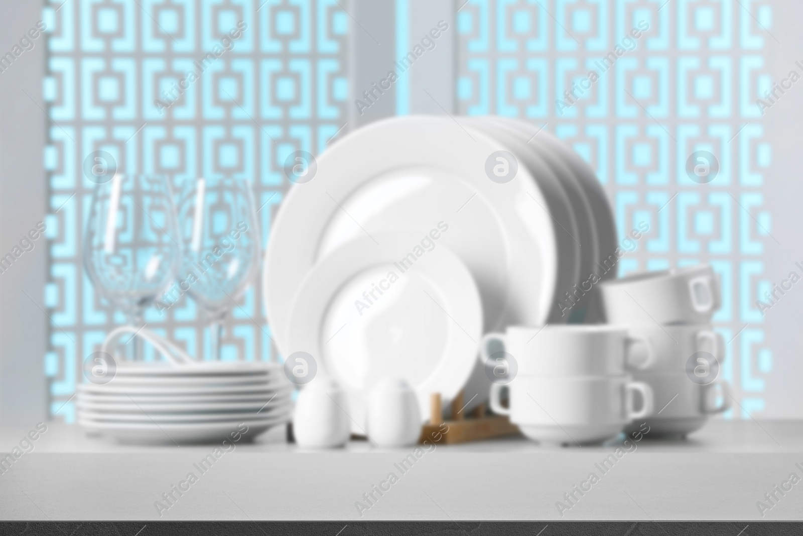 Image of Set of clean dishware, focus on empty stone table