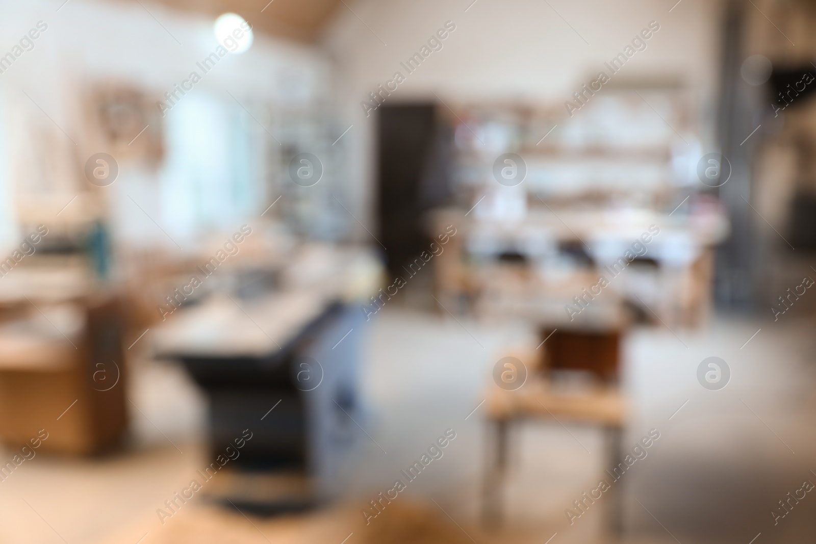 Photo of Blurred view of carpentry shop interior. Working space