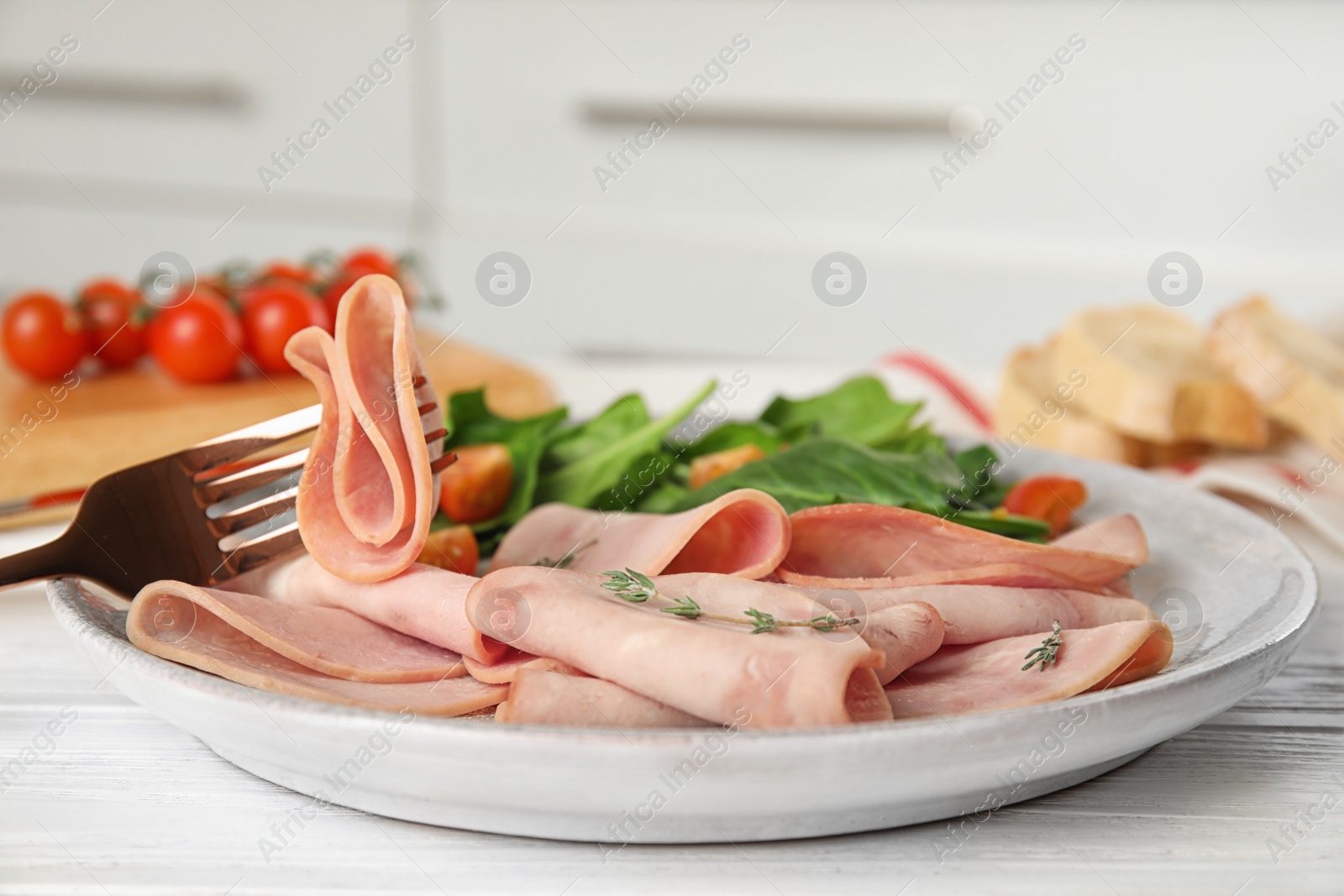 Photo of Tasty ham on white wooden table, closeup