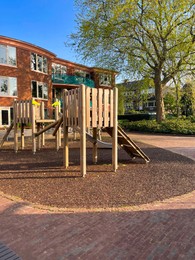 Outdoor playground for children near house on sunny day