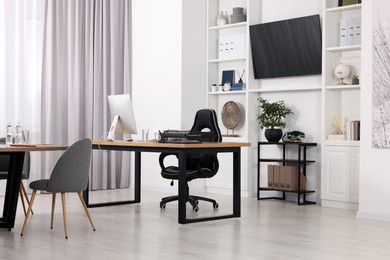 Photo of Stylish office with comfortable furniture and tv zone. Interior design