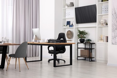 Stylish office with comfortable furniture and tv zone. Interior design