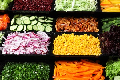 Photo of Salad bar with different fresh ingredients as background