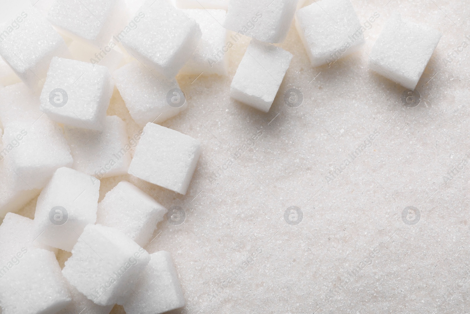 Photo of Different types of sugar as background, top view. Space for text