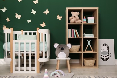 Photo of Beautiful baby room interior with comfortable crib