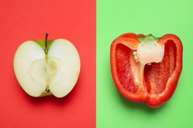 Photo of Cut apple and bell pepper on color background, flat lay