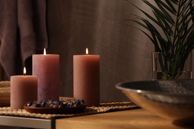 Photo of Spa composition. Burning candles and dry flowers on table indoors