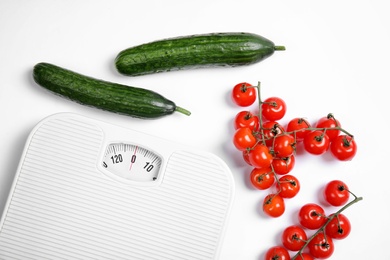 Composition with scales and vegetables on white background, top view