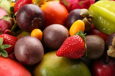 Assortment of fresh exotic fruits as background, closeup