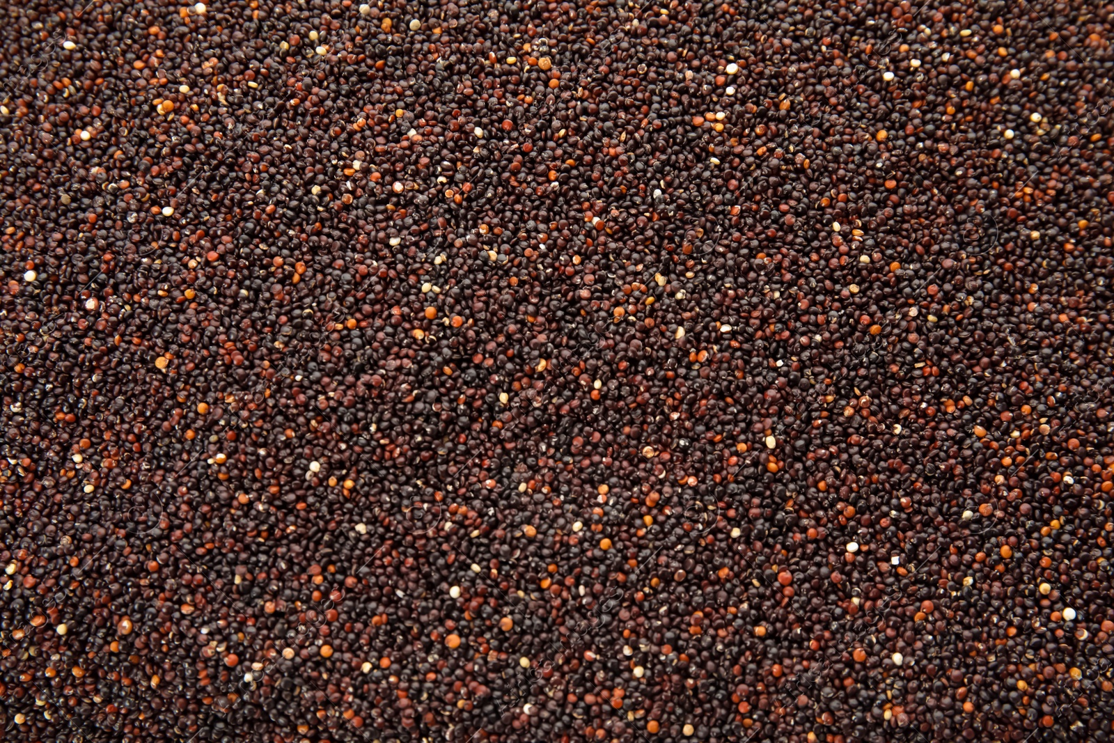 Photo of Raw black quinoa seeds as background, closeup