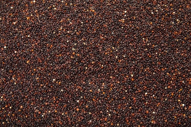 Raw black quinoa seeds as background, closeup