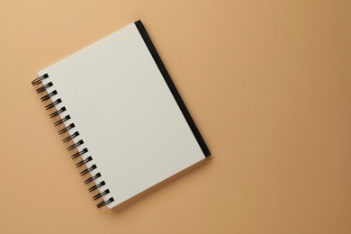 Photo of Blank notebook on beige background, top view. Space for text