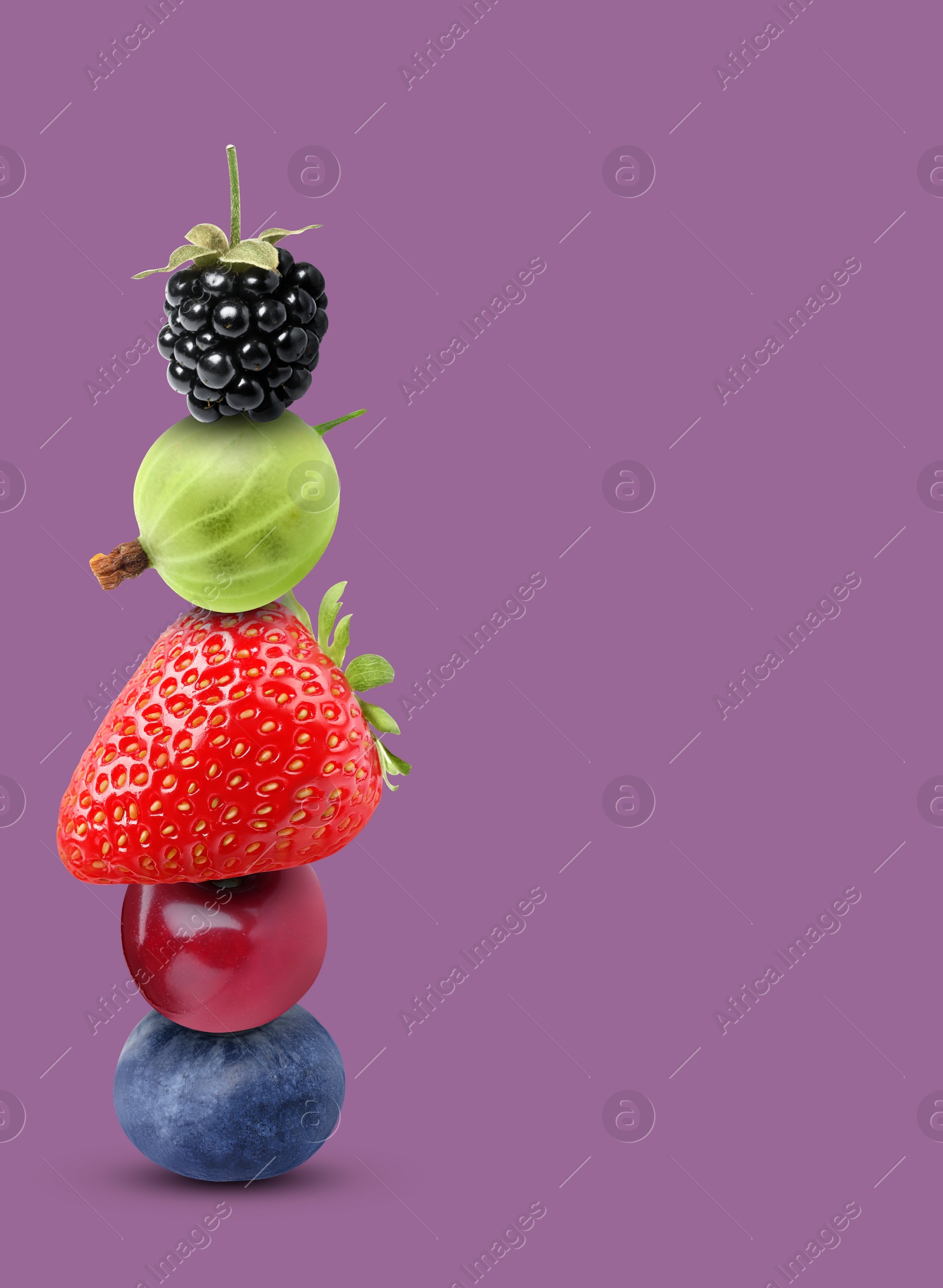 Image of Stack of different fresh tasty berries and cherry on pale purple background, space for text