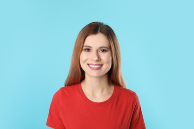 Photo of Smiling woman with perfect teeth on color background