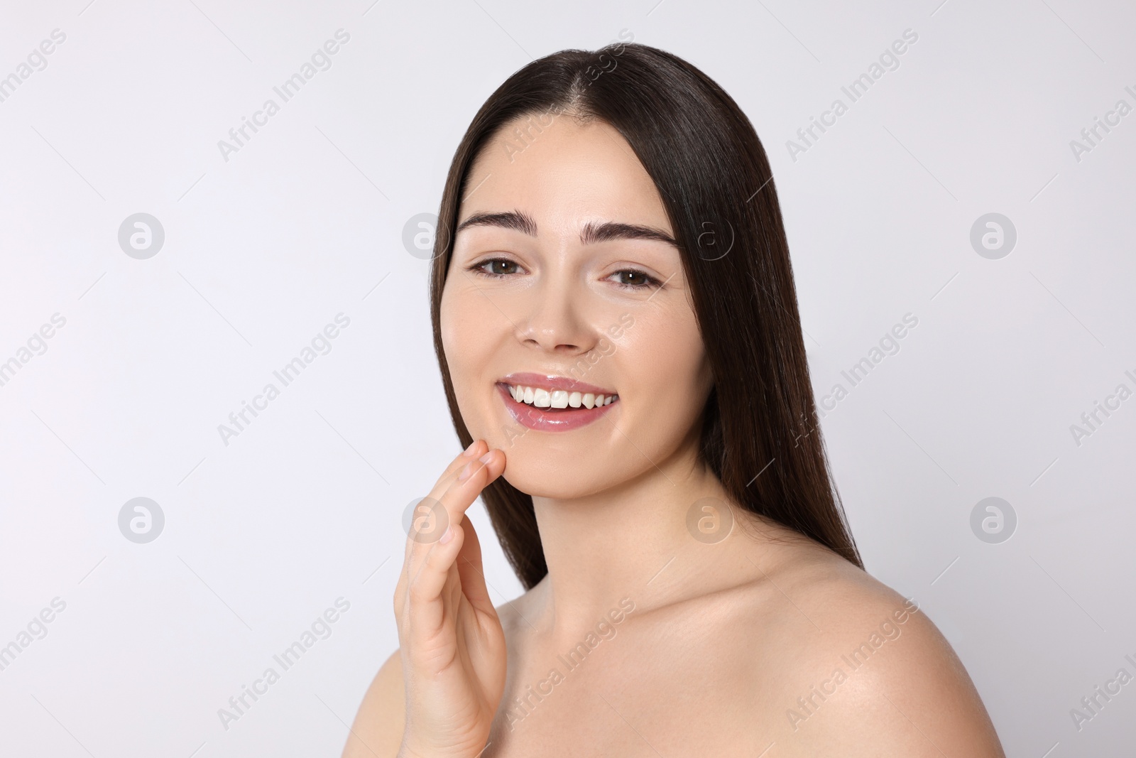 Photo of Portrait of attractive young woman on light grey background. Spa treatment