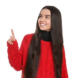 Photo of Teenage girl pointing at something on white background