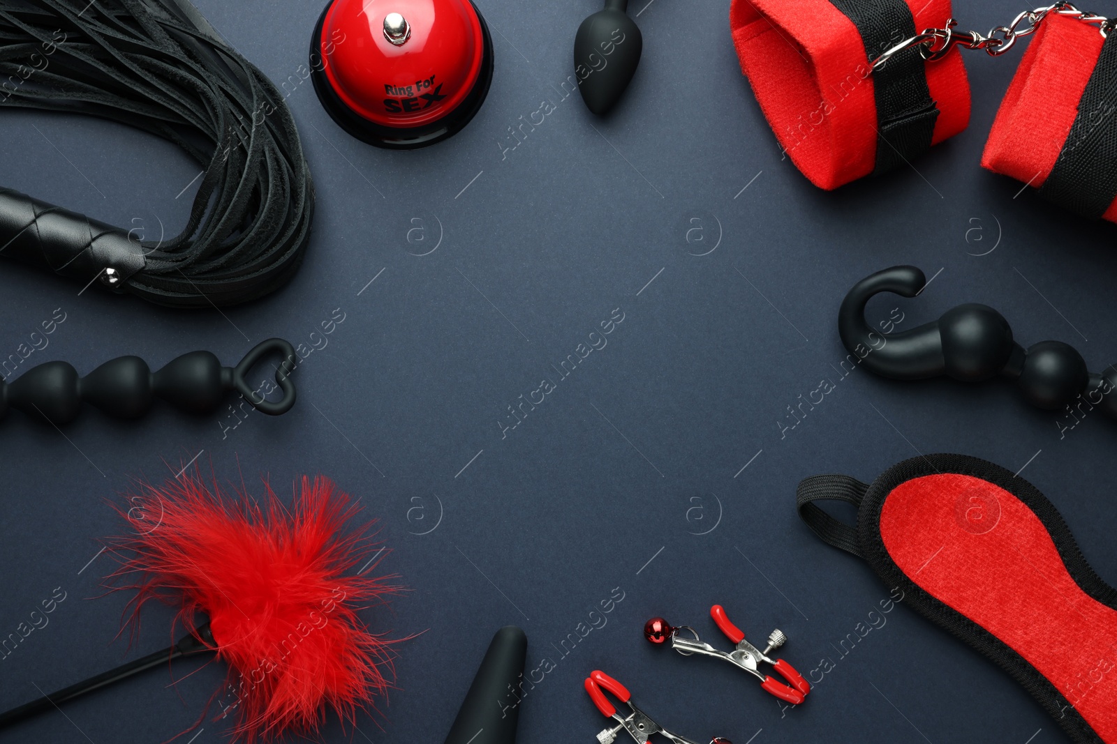 Photo of Flat lay composition with different sex toys on dark blue background, space for text