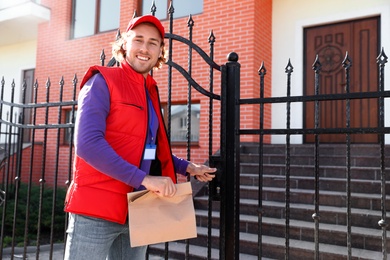 Male courier delivering food in city on sunny day