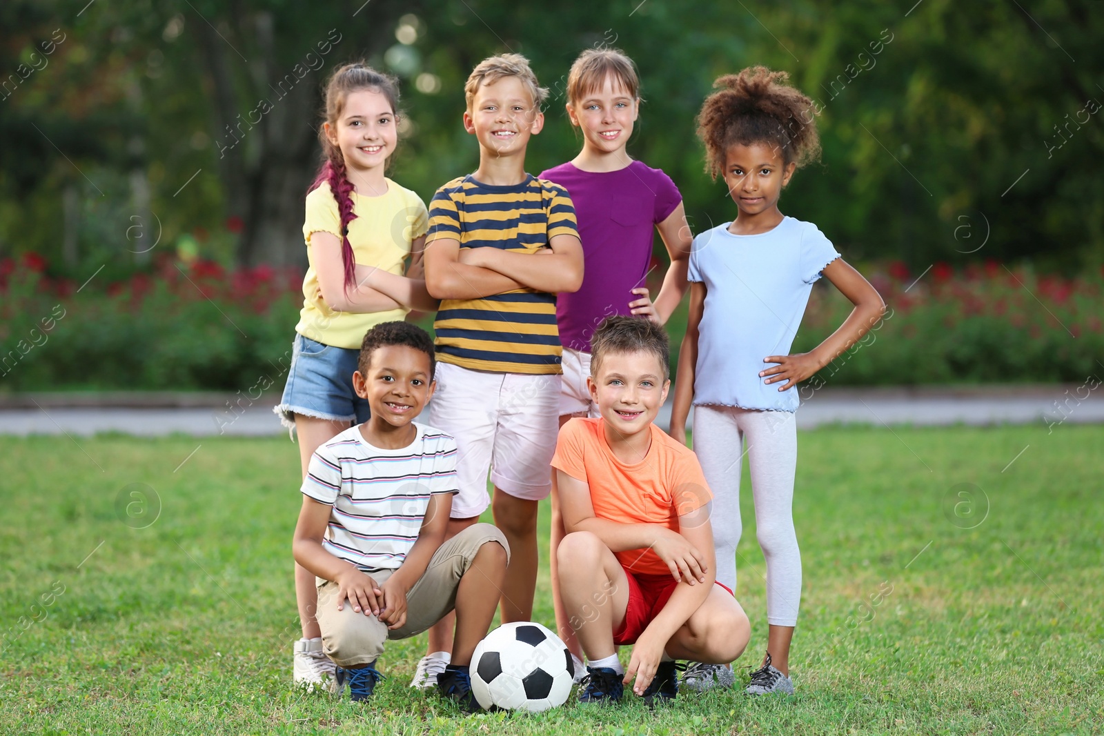 Photo of Cute little children with soccer ball in park. Outdoor play