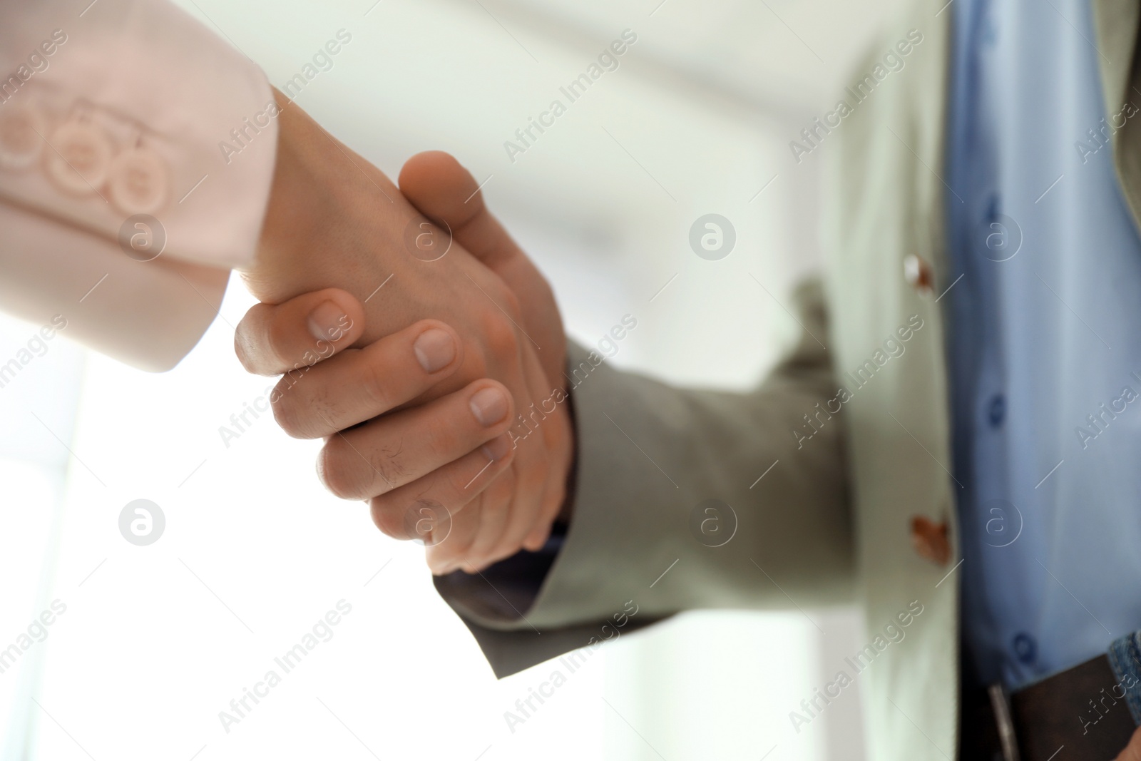 Photo of Business partners shaking hands after meeting, closeup