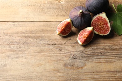 Fresh ripe figs on wooden table. Space for text